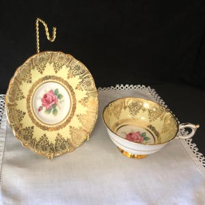 Rare Paragon tea or coffee cup and saucer; pink rose center, yellow background & elegant, extensive gold trim; made in England c 1952-1960s