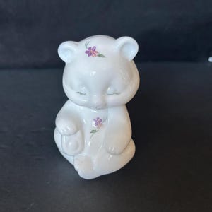 Fenton milk glass bear figurine; hand painted with small purple flowers & signed by artist; with original sticker; made in USA ca 1982-1985