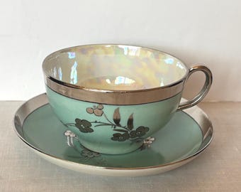 Mid-century hand decorated tea or coffee cup & saucer; blue with silver/platinum band and florals; unmarked; ca 1950s-1960s