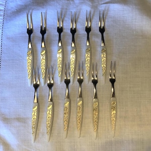Set of 12 Adriane cocktail/appetizer mini hostess forks; plastic & stainless steel; ivory and gold tone handles; made in Japan; ca 1960s