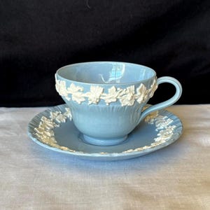 Wedgwood Queensware embossed cream on Lavender (blue) cup and saucer; made in England ca 1940s