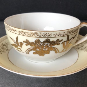 Antique Noritake art deco tea or coffee cup and saucer, hand painted; cream and white with embossed/filigree gold; c 1918-1920.