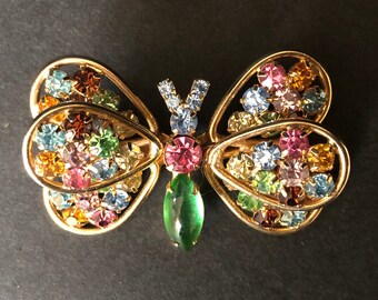 Signed Judy Lee jeweled butterfly brooch/pin; gold tone with multi-color pastel rhinestones and possible green Lucite tail, ca 1950s-1960s