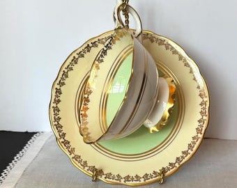 Rare Royal Stafford bone china tea/coffee cup & saucer; mint green, cream/ivory with gold filigree and medallion pattern; England 1940-60s