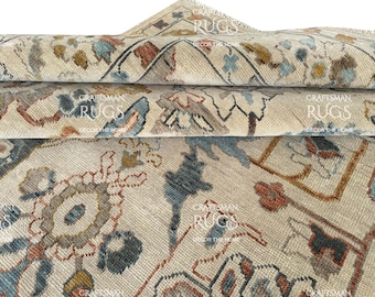 May include: Close-up of rolled beige rugs with intricate floral and geometric patterns in shades of blue, rust, and gold. The rugs have a distressed, vintage look, with visible text reading "Craftsman Rugs, Decor the Home."