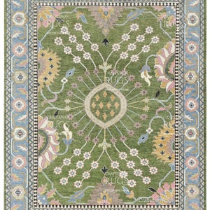 May include: A rectangular green rug with a floral design and a light blue border. The rug features a central medallion and repeating floral patterns in pink, yellow, and white. The text "Craftsman Rugs" is visible.