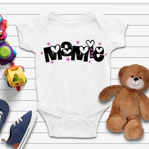 May include: White baby onesie with black text that says "Mamie" with pink hearts and stars around the text.