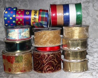 May include: A collection of decorative ribbon spools in various colors and patterns. The spools include polka dots, stripes, plaid, and metallic gold and red designs. Some ribbons have the word "celebrate" printed on them.
