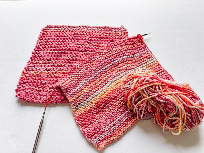 100% cotton dishcloth/washcloth in hues of pink on knitting needles
