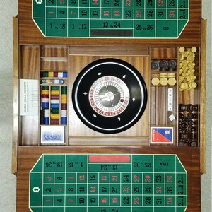May include: A wooden roulette game set with a green felt playing surface, a spinning wheel, and various chips and accessories. The set includes a roulette wheel, chips, and a card deck.