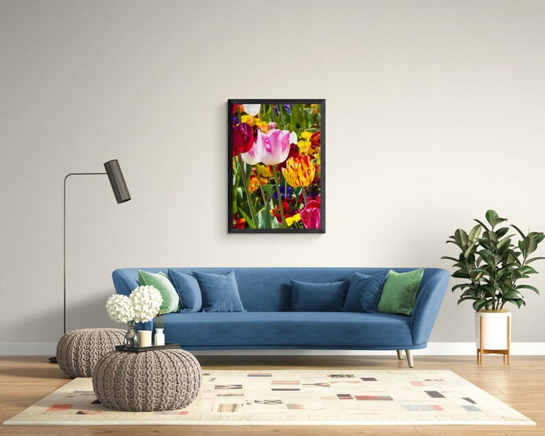 May include: A framed print of a colorful bouquet of tulips in shades of pink, red, yellow, and orange. The tulips are arranged in a vase and are surrounded by green leaves.