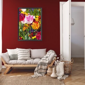 May include: A framed photograph of a colorful bouquet of tulips in various shades of red, pink, yellow, and orange. The tulips are arranged in a vase and are surrounded by green leaves.