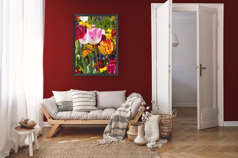 May include: A framed photograph of a colorful bouquet of tulips in various shades of red, pink, yellow, and orange. The tulips are arranged in a vase and are surrounded by green leaves.
