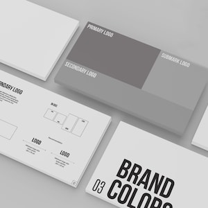 May include: A brand guide with a white background and black text. The guide includes information about the primary logo, secondary logo, submark logo, and brand colors. The text "THE LOGO" is at the top of the page.