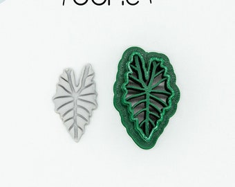 May include: Two 3D printed leaf-shaped cookie cutters. The larger cutter is green and the smaller cutter is grey. Both cutters are made of PLA plant-based plastic, non-toxic.