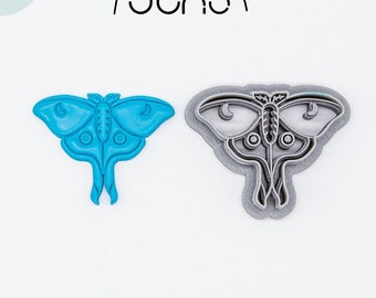 May include: Two 3D printed cookie cutters in the shape of a luna moth. The cutter on the left is blue and the cutter on the right is gray.