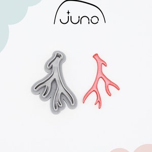 May include: Two coral-shaped 3D printed cutters. One is silver, the other is red. The cutters are made of PLA plant-based plastic. The word "juno" is above the cutters.