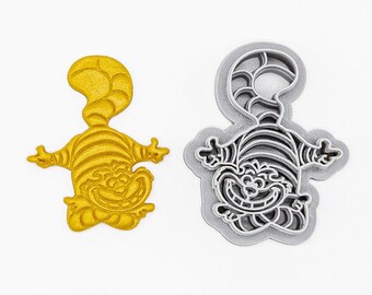 May include: A 3D printed cookie cutter in the shape of a Cheshire Cat from Alice in Wonderland. The cutter is made of PLA plant-based plastic and is non-toxic. The cutter is shown in both its yellow and gray forms.