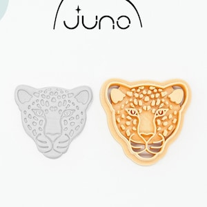 May include: A 3D printed cookie cutter in the shape of a leopard's face. The cutter is made of PLA plant-based plastic and is non-toxic. The cutter is shown in both its natural white color and a light brown color.