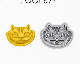 May include: Two 3D printed cookie cutters shaped like the Cheshire Cat from Alice in Wonderland. The cutters are made of PLA plant-based plastic and are non-toxic. One cutter is yellow and the other is gray.