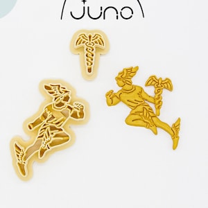 May include: Three 3D printed cookie cutters made of plant-based plastic. The cutters are shaped like a winged figure holding a staff, a winged figure running, and a staff with a snake wrapped around it. The cutters are a light yellow colour.