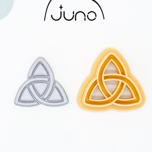 May include: A 3D printed cookie cutter in the shape of a Celtic knot. The cutter is made of PLA plant-based plastic and is non-toxic. The cutter is shown in two views: one with a silver finish and one with a gold finish.