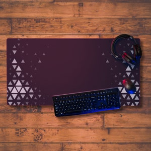May include: A black keyboard and mouse are on a purple gaming mousepad with a white geometric pattern. A pair of black headphones are on the mousepad.