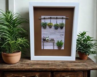 Framed Pebble Art - Plants hanging with table and books