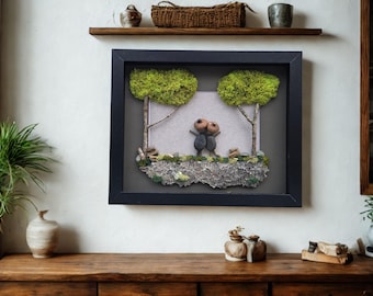 Framed Pebble Art - Acorn Hat Couple with gray and black background