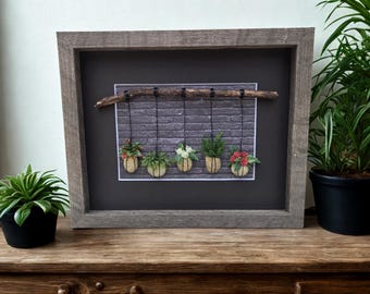 Framed Pebble Art - Hanging Plants with brick background