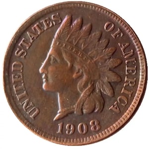 May include: A copper-colored 1908 Indian Head penny. The obverse features a profile of a Native American in a feathered headdress, with the words "UNITED STATES OF AMERICA" and "LIBERTY" inscribed. The year "1908" is also visible.
