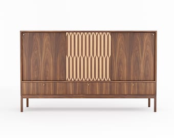 May include: A mid-century modern style walnut wood cabinet with three drawers and two sliding doors. One door features a geometric pattern of light wood.