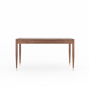 May include: A dark brown wooden desk with three drawers and brass hardware. The desk has tapered legs and a rectangular top.