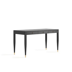 May include: A black wooden desk with three drawers and gold-toned hardware. The desk has tapered legs.