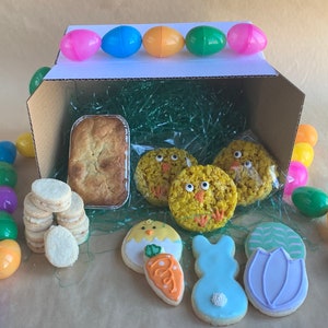 Items included in the gluten free Easter Treat Box include mini mandarin cardamom pound cake, decorated easter sugar cookies, 3 brown butter & sea salt treats in the shape of chicks and 6 lemon and pistachio shortbread