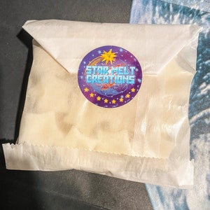 May include: A white paper bag with a purple and blue sticker that says "Star Melt Creations" with a yellow sun and a shooting star graphic.