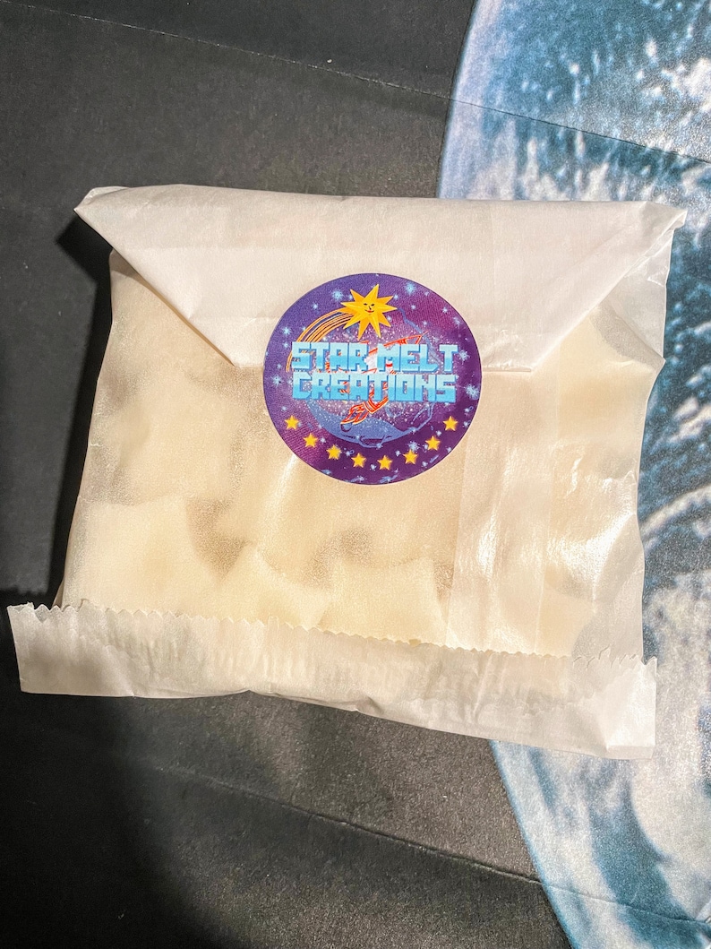 May include: A white paper bag with a purple and blue sticker that says "Star Melt Creations" with a yellow sun and a shooting star graphic.