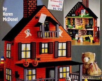May include: Plastic canvas pattern for a haunted dollhouse. The pattern features a red and black house with a porch, ghosts, pumpkins, and a black cat. The pattern is by Karen McDaniel and is titled "Haunted Dollhouse".