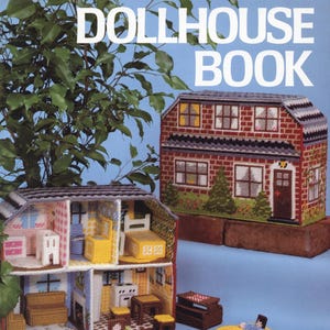 May include: A book cover featuring a plastic canvas dollhouse project. The cover displays two completed dollhouses, one open to reveal interior rooms and furnishings. The text "Plastic Canvas DOLLHOUSE BOOK" is prominently displayed.