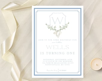 May include: A blue and white invitation card with a decorative monogram of the letter "W" surrounded by green leaves. The text reads "Join us for some birthday fun our little Wells is turning one. Saturday, September 16th 11 o'clock in the morning 256 North McAllister Alley Fayetteville, KY 72703. RSVP 812-288-8010"