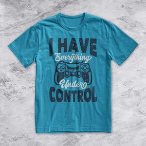 May include: A turquoise blue t-shirt with a distressed black graphic of a video game controller and the text "I HAVE Everything Under CONTROL".