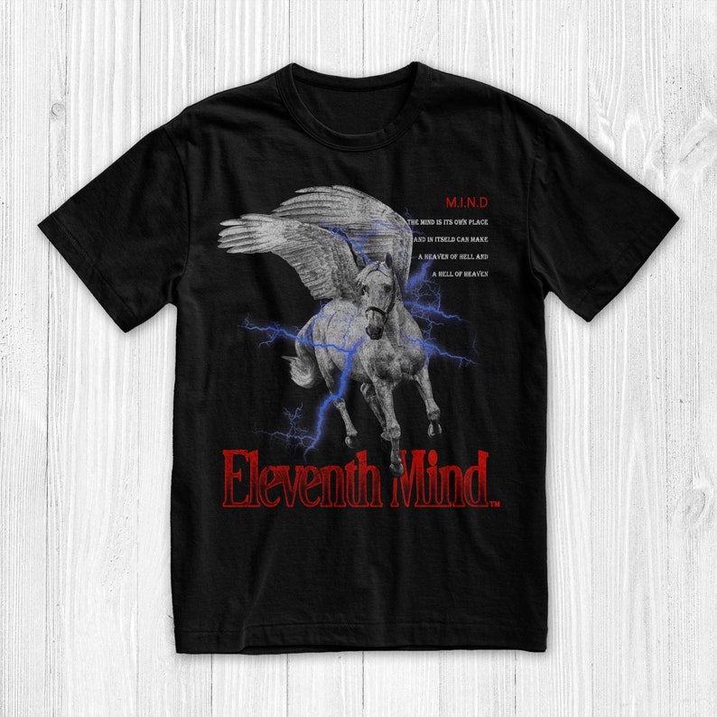 May include: Black t-shirt featuring a white winged horse graphic and the text "Eleventh Mind" in red. The text "M.I.N.D" is also on the shirt with the text "THE MIND IS ITS OWN PLACE AND IN ITSELF CAN MAKE A HEAVEN OF HELL AND A HELL OF HEAVEN".