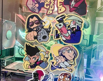 May include: A collection of colorful stickers featuring various cartoon characters, including a woman with pink hair, a man with a beard, and a robot. The stickers are on a black and silver background. One sticker says "Skippy: You are the best user I know!"