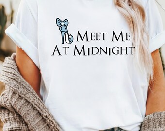 May include: White t-shirt with a blue glass slipper and the text "Meet Me At Midnight".