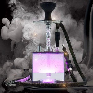 May include: A clear glass hookah with a black bowl and a purple LED light base. The hookah has a silver stem and a black hose.