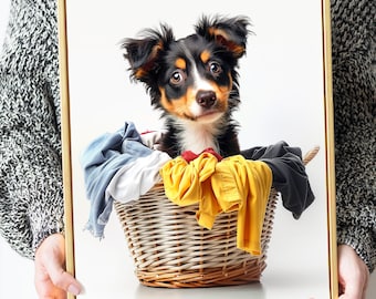 May include: A black and brown puppy sits in a wicker basket filled with colorful laundry. The puppy is looking directly at the camera.