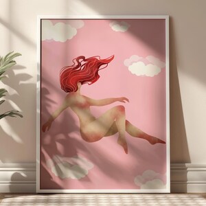May include: A framed art print featuring a nude figure with flowing red hair floating in a pink sky with white clouds. The artwork has a soft, ethereal quality, with the figure's form subtly rendered.