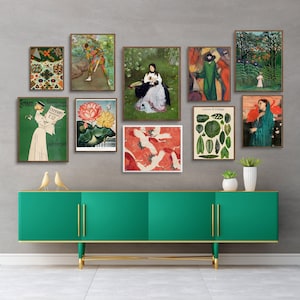 May include: A green dresser with gold accents and a collection of framed vintage prints featuring botanical illustrations, a woman reading a newspaper, and a woman in a garden. The prints are arranged on a gray wall above the dresser.