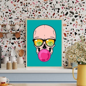 May include: A framed illustration of a pink skull wearing sunglasses with a blue and green wave pattern reflected in the lenses. The skull is blowing a pink bubble.