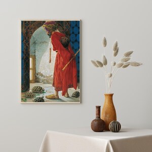 May include: A man in a red robe and turban stands in a doorway, holding a long staff. He is looking at a group of tortoises on the floor. The doorway is decorated with intricate tile work.